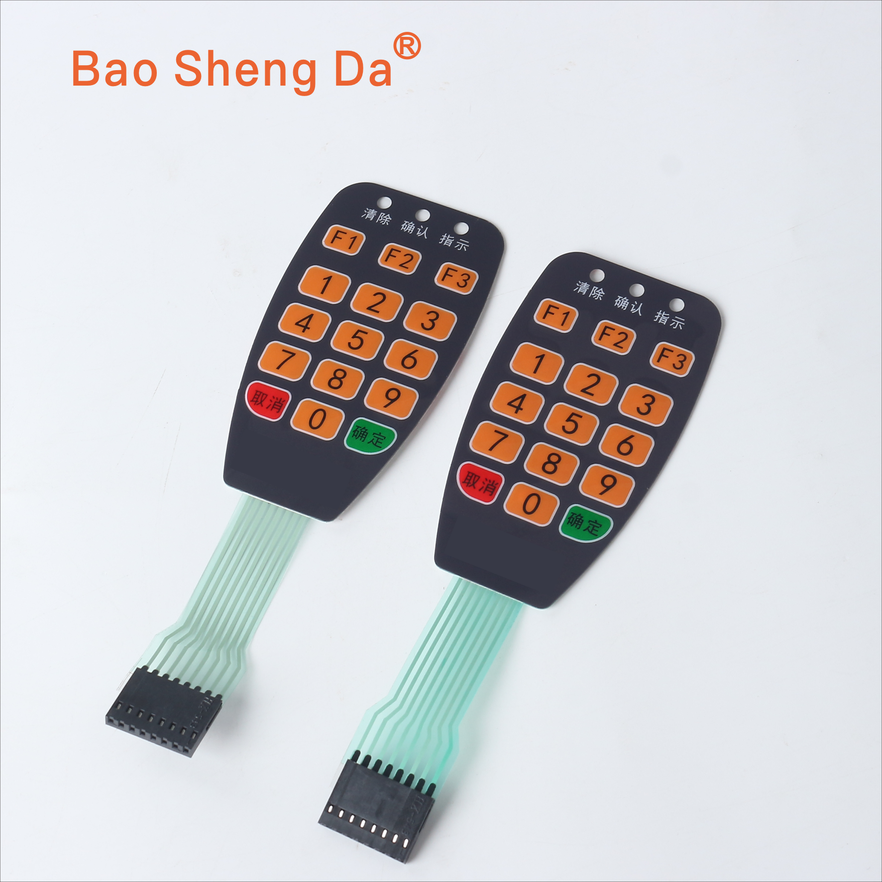 Two complete black and orange membrane keypads with green tails and connector housings